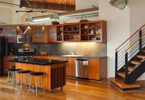 Kitchen with wooden cupboards and black worktop