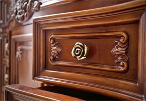 Close up of wooden drawer with golden flower handle
